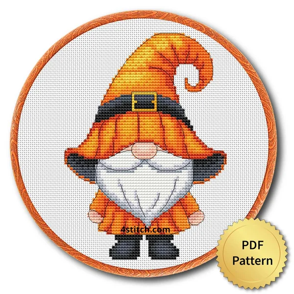 Orange Witch Gnome displayed on white Aida in a wooden embroidery hoop with a PDF pattern badge