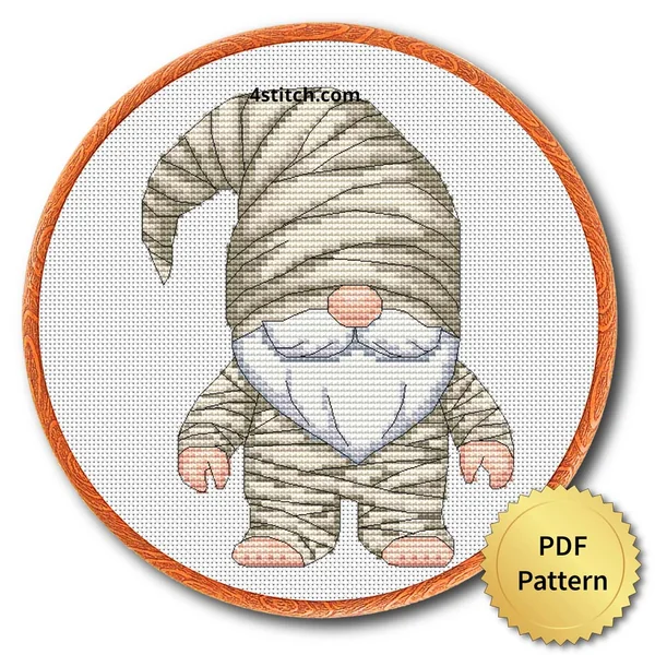 Mummy Halloween Gnome displayed on white Aida in a wooden embroidery hoop with a PDF pattern badge