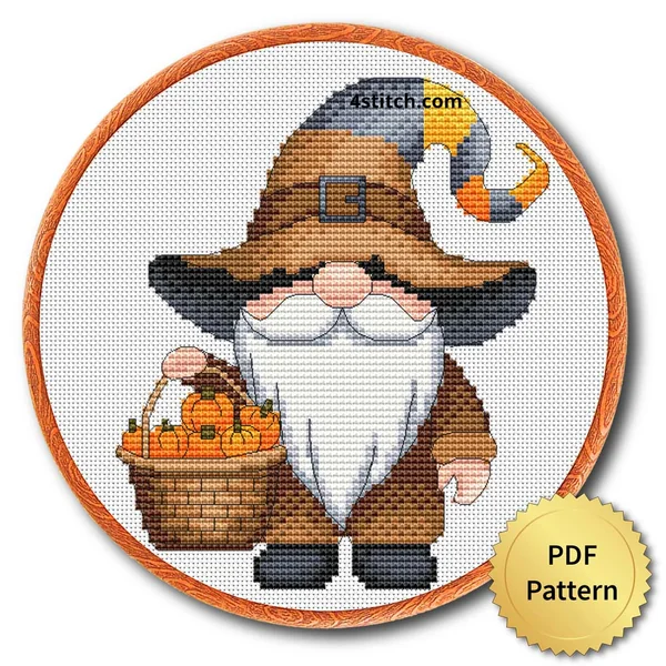 Pumpkin Basket Witch Gnome displayed on white Aida in a wooden embroidery hoop with a PDF pattern badge
