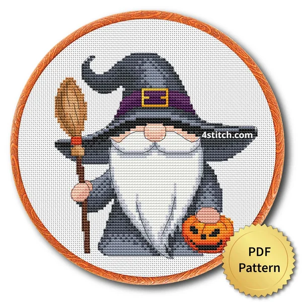 Broom and Pumpkin Witch Gnome displayed on white Aida in a wooden embroidery hoop with a PDF pattern badge