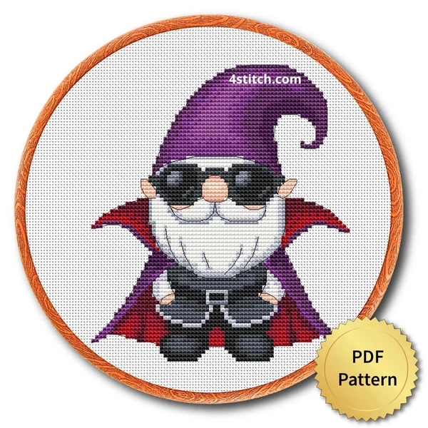 Sunglasses Vampire Gnome displayed on white Aida in a wooden embroidery hoop with a PDF pattern badge