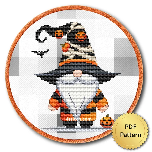 Mummy Hat Halloween Gnome displayed on white Aida in a wooden embroidery hoop with a PDF pattern badge