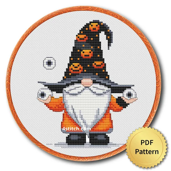 Pumpkin Stack Eyeball Gnome displayed on white Aida in a wooden embroidery hoop with a PDF pattern badge