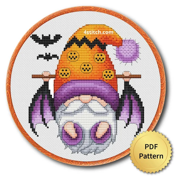 Bat-Wing Pumpkin Halloween Gnome displayed on white Aida in a wooden embroidery hoop with a PDF pattern badge