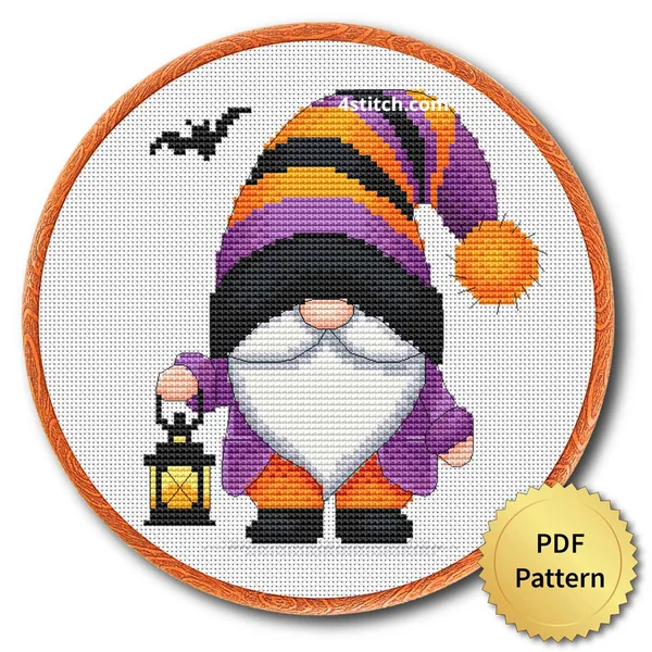 Lantern Striped-Hat Halloween Gnome displayed on white Aida in a wooden embroidery hoop with a PDF pattern badge