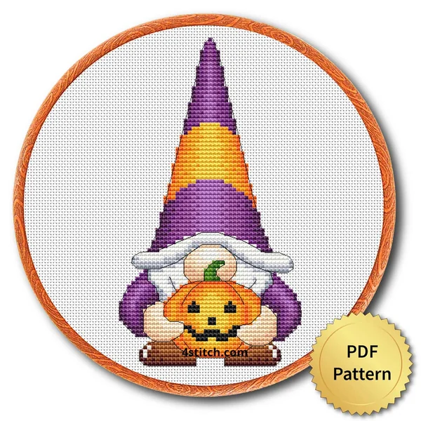Pumpkin Hug Halloween Gnome displayed on white Aida in a wooden embroidery hoop with a PDF pattern badge