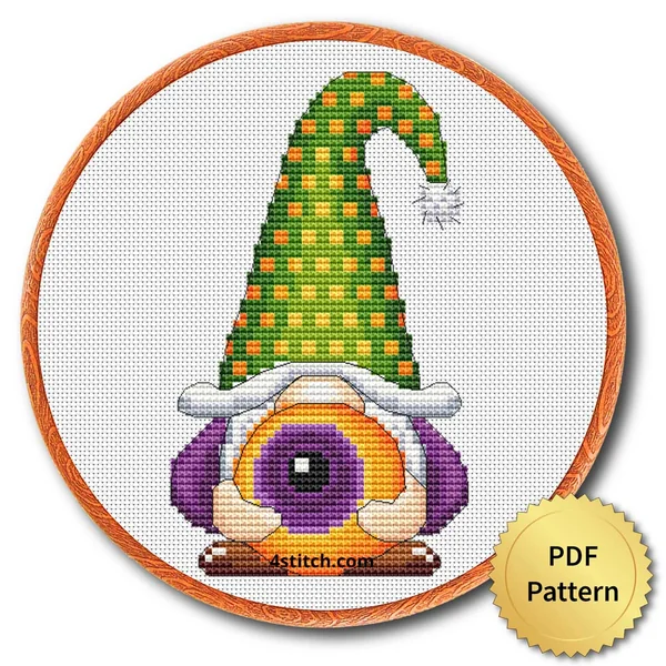 Eyeball Hat Halloween Gnome displayed on white Aida in a wooden embroidery hoop with a PDF pattern badge