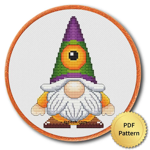 Cyclops Halloween Gnome displayed on white Aida in a wooden embroidery hoop with a PDF pattern badge