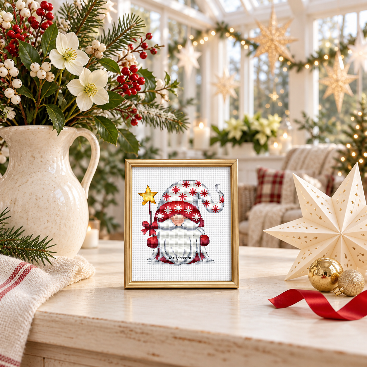 Christmas Star Gnome with a golden star on a ribboned wand and a red-and-white snowflake-patterned hat, on white Aida in a champagne-gold frame in a sunny star-themed holiday room.
