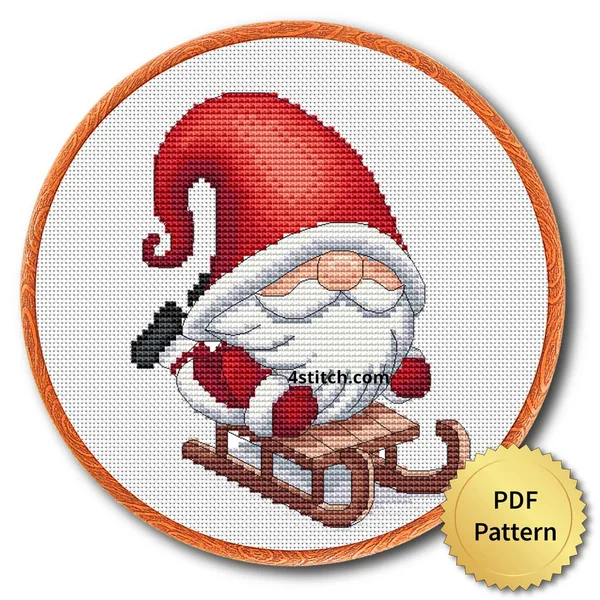 Sled Riding Santa Gnome cross stitch design in an embroidery hoop with a PDF Pattern medal