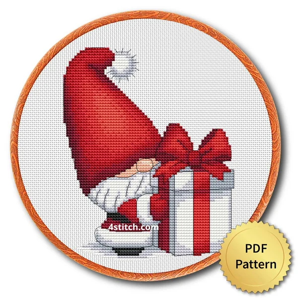Giant Gift Box Santa Gnome cross stitch design in an embroidery hoop with a PDF Pattern medal