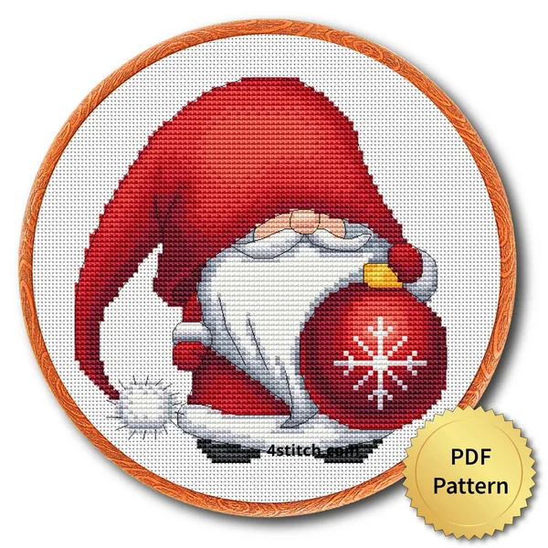 Red Snowflake Bauble Gnome cross stitch design in an embroidery hoop with a PDF Pattern medal