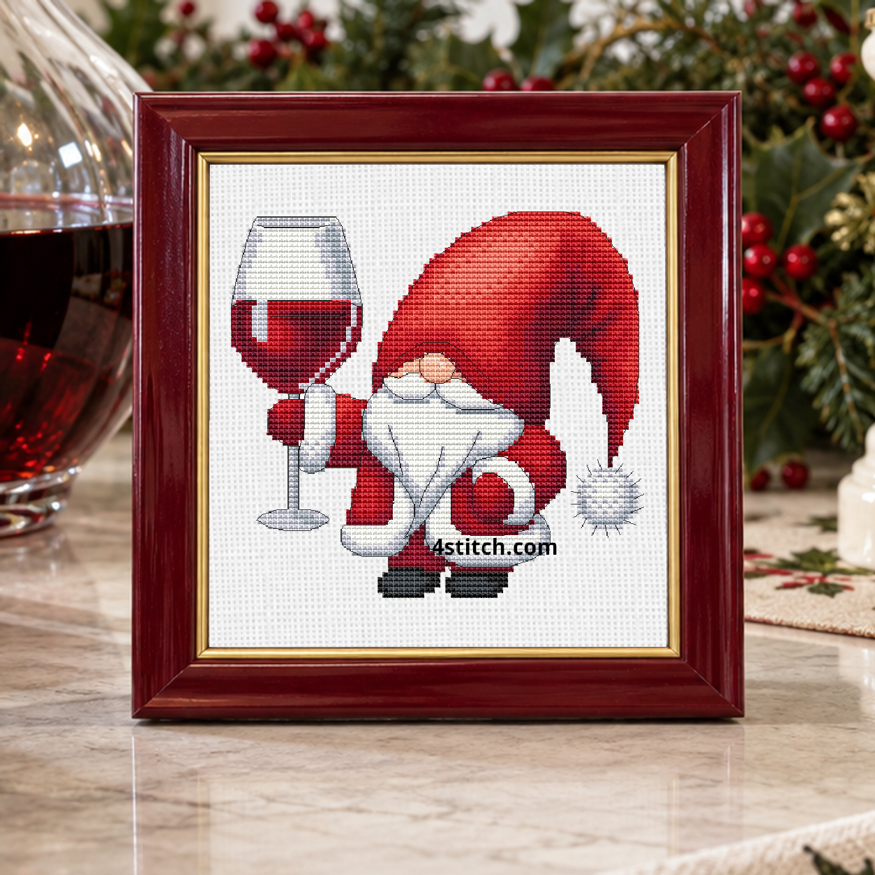 Close-up of Christmas Toast Santa Gnome on white Aida in a burgundy-and-gold frame on a sunlit Christmas dining sideboard.
