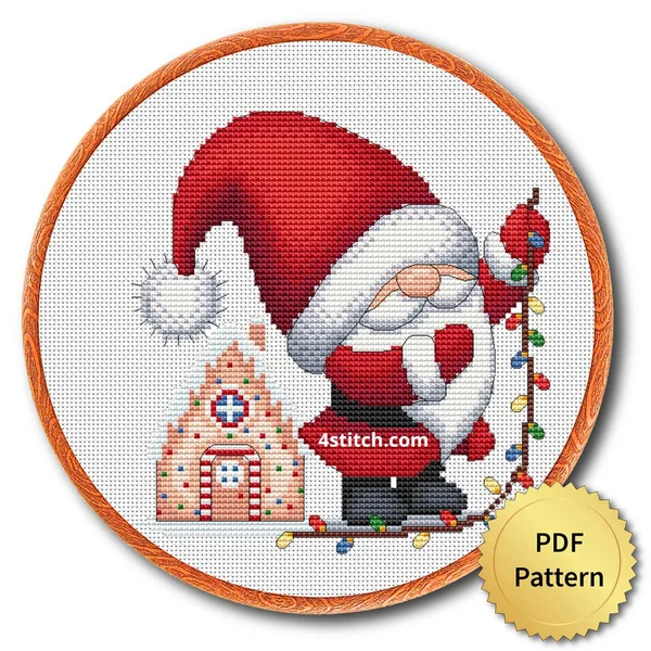 Gingerbread House Lights Gnome cross stitch design in an embroidery hoop with a PDF Pattern medal