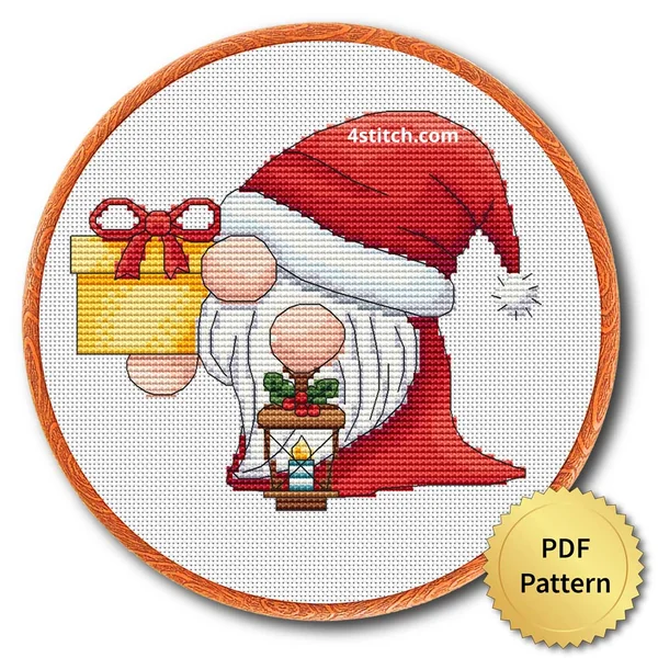 Finished christmas gift and lantern gnomes cross stitch design in a wooden embroidery hoop