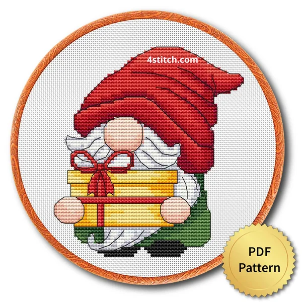 Finished christmas gift gnome cross stitch design in a wooden embroidery hoop