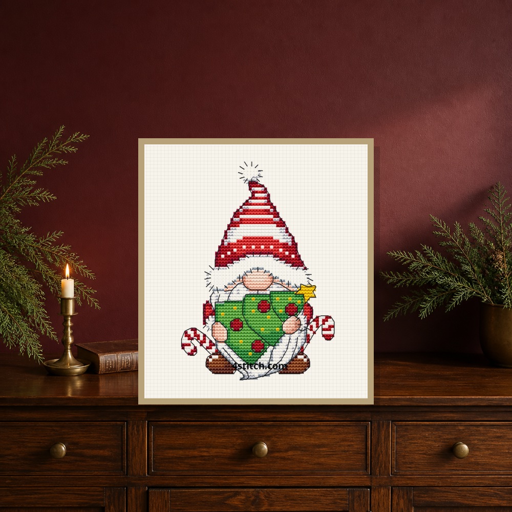 Exact Christmas Ornament Gnome Cross Stitch Pattern stitched motif in a small tabletop frame within a Christmas interior, marked 4stitch.com