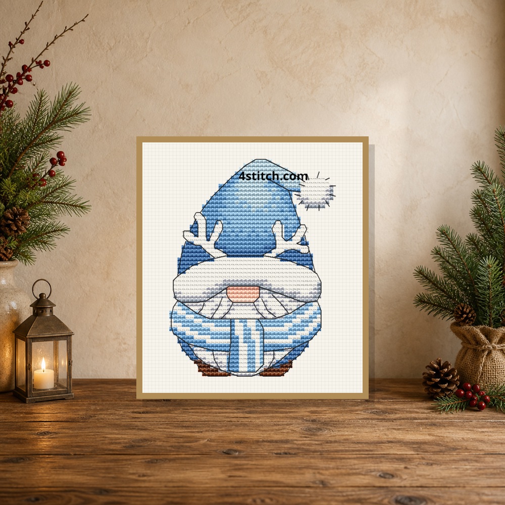 Exact Reindeer Mug Winter Gnome Cross Stitch Pattern stitched motif in a small tabletop frame within a Christmas interior, marked 4stitch.com