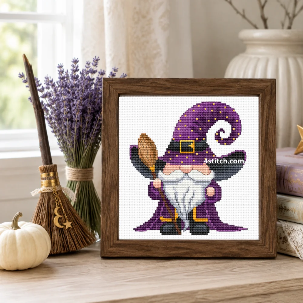 Framed Purple Broom Witch Gnome cross stitch on white Aida in a bright lavender Halloween interior