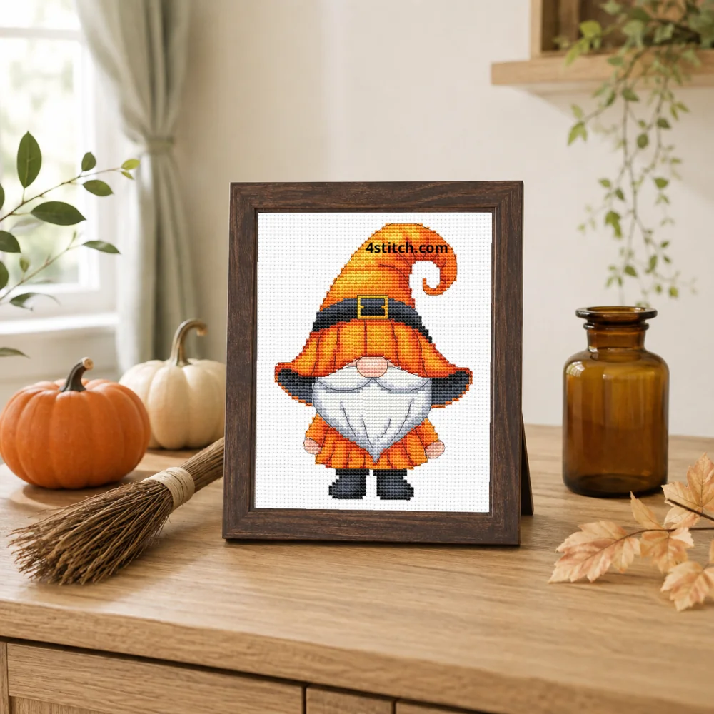 Framed Orange Witch Gnome cross stitch on one white Aida canvas in a bright Halloween interior