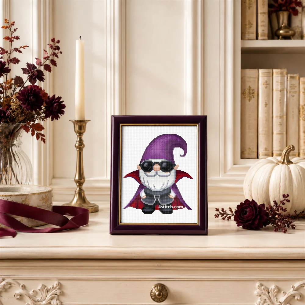 Framed Sunglasses Vampire Gnome cross stitch on white Aida in a bright elegant Halloween interior