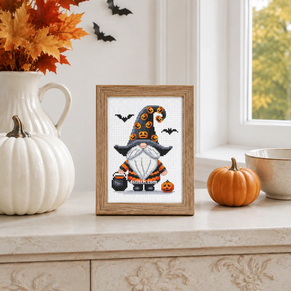 Small framed Pumpkin Hat Halloween Gnome stitched on white Aida in a bright themed interior; complete original motif and 4stitch.com watermark.