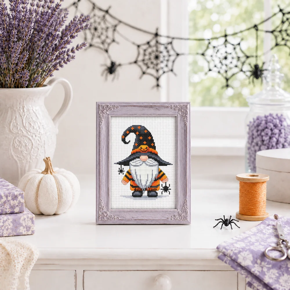 Small framed Spider Pumpkin Witch Gnome stitched on white Aida in a bright themed interior; complete original motif and 4stitch.com watermark.