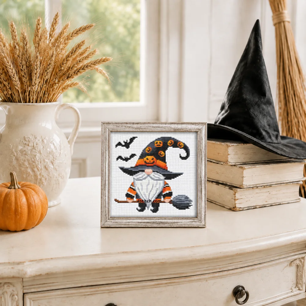 Small framed Flying Broom Witch Gnome stitched on white Aida in a bright themed interior; complete original motif and 4stitch.com watermark.