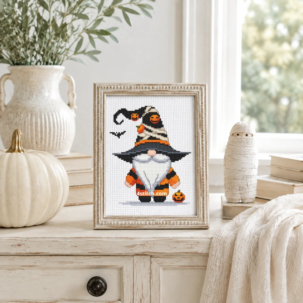Small framed Mummy Hat Halloween Gnome stitched on white Aida in a bright themed interior; complete original motif and 4stitch.com watermark.