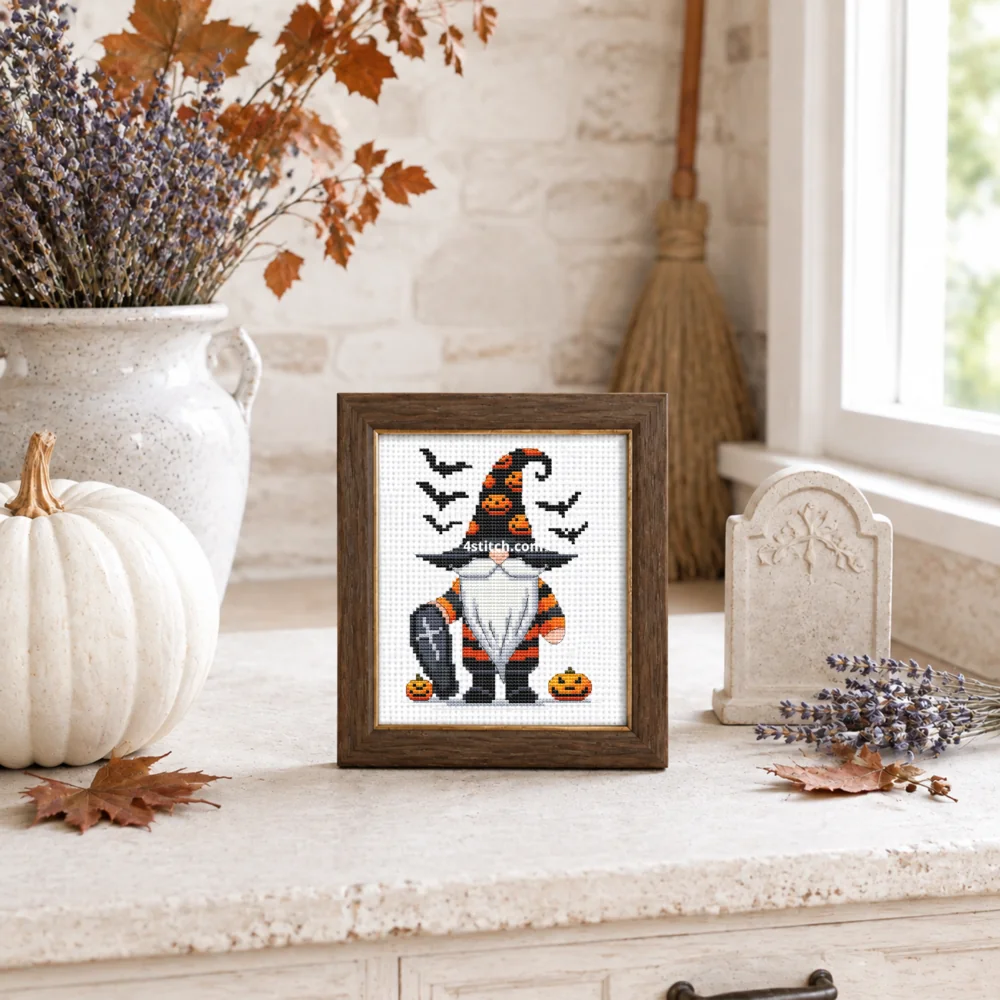 Small framed graveyard Halloween Gnome stitched on white Aida in a bright themed interior; complete original motif and 4stitch.com watermark.