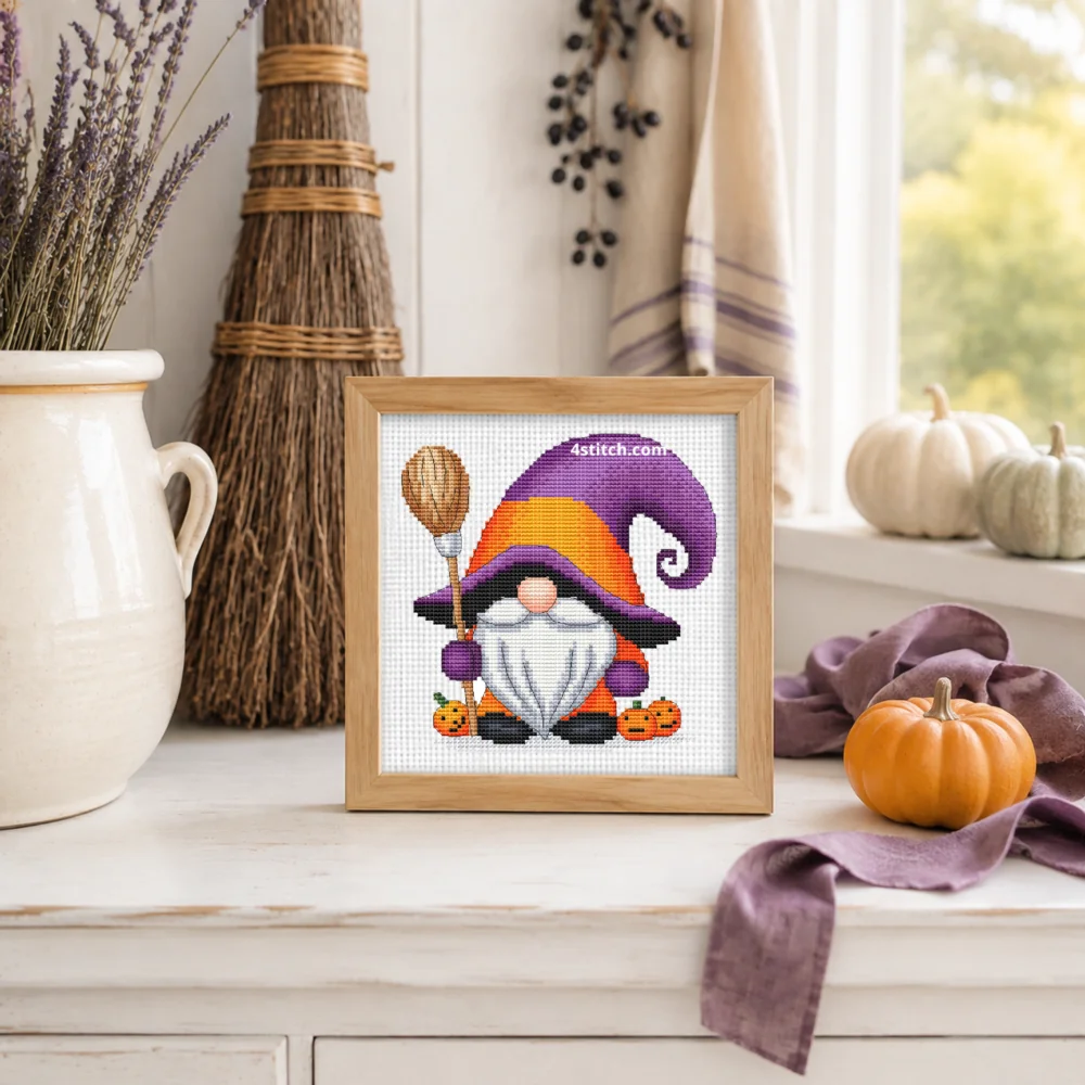 Small framed Purple and Orange Witch Gnome on white Aida in a bright themed interior, with the complete original motif and its 4stitch.com watermark.