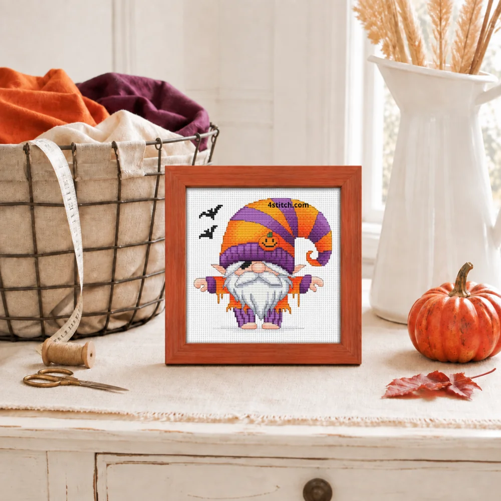 Small framed Striped Hat Halloween Gnome on white Aida in a bright themed interior, with the complete original motif and its 4stitch.com watermark.