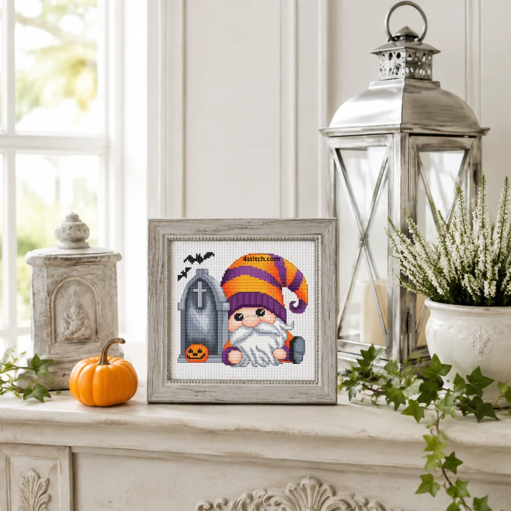Small framed Sleepy Tombstone Halloween Gnome on white Aida in a bright themed interior, with the complete original motif and its 4stitch.com watermark.