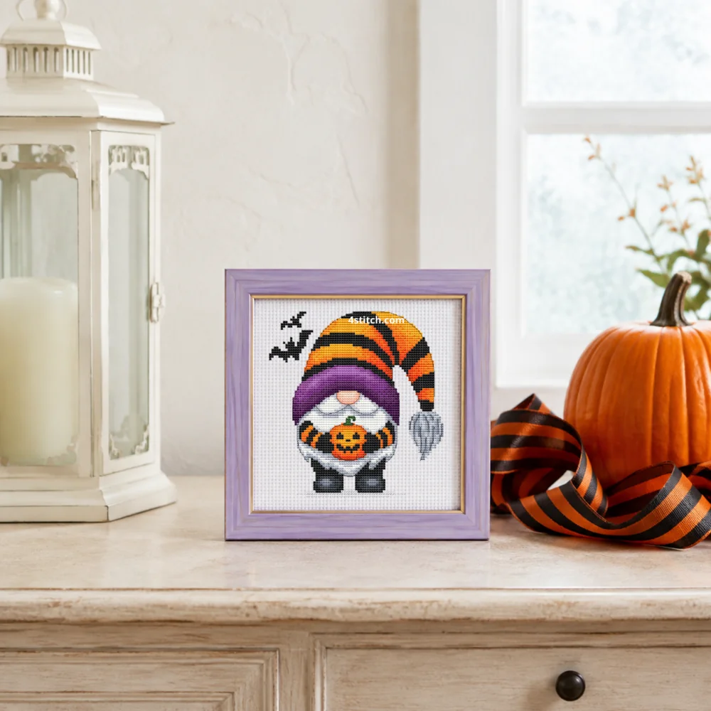 Small framed Pumpkin Basket Striped Hat Gnome on white Aida in a bright themed interior, with the complete original motif and its 4stitch.com watermark.