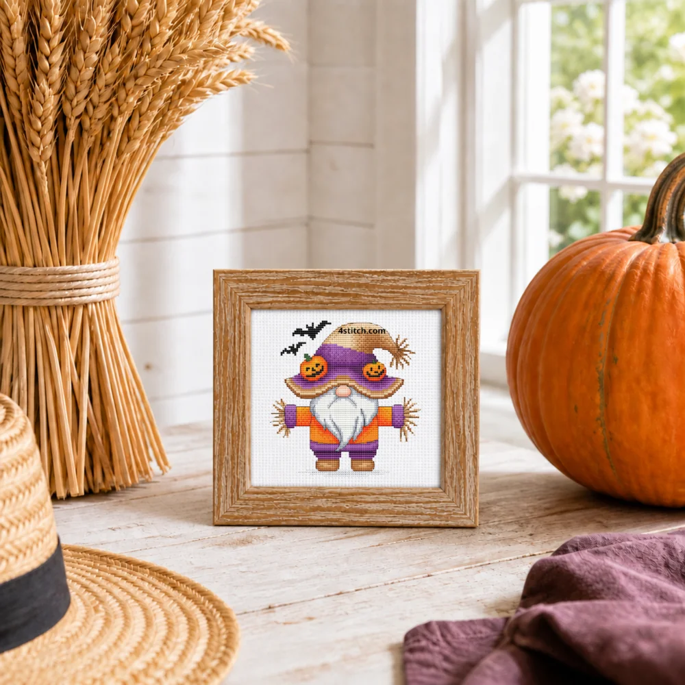 Small framed Scarecrow Pumpkin Hat Gnome on white Aida in a bright themed interior, with the complete original motif and its 4stitch.com watermark.