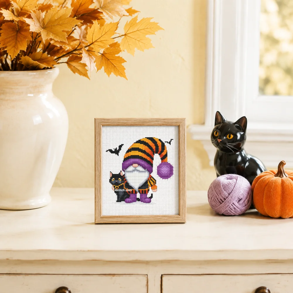 Small framed Striped-Hat Black Cat Gnome on white Aida in a bright themed interior, with the complete original motif and its 4stitch.com watermark.