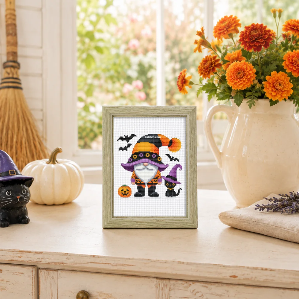 Small framed Black Cat Witch Halloween Gnome on white Aida in a bright themed interior, with the complete original motif and its 4stitch.com watermark.