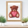 Bear with heart cross stitch pattern featuring a cute brown bear holding a heart
