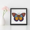 A cross stitch pattern featuring a beautiful mandala butterfly