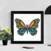 A cross stitch pattern featuring a beautiful mandala butterfly