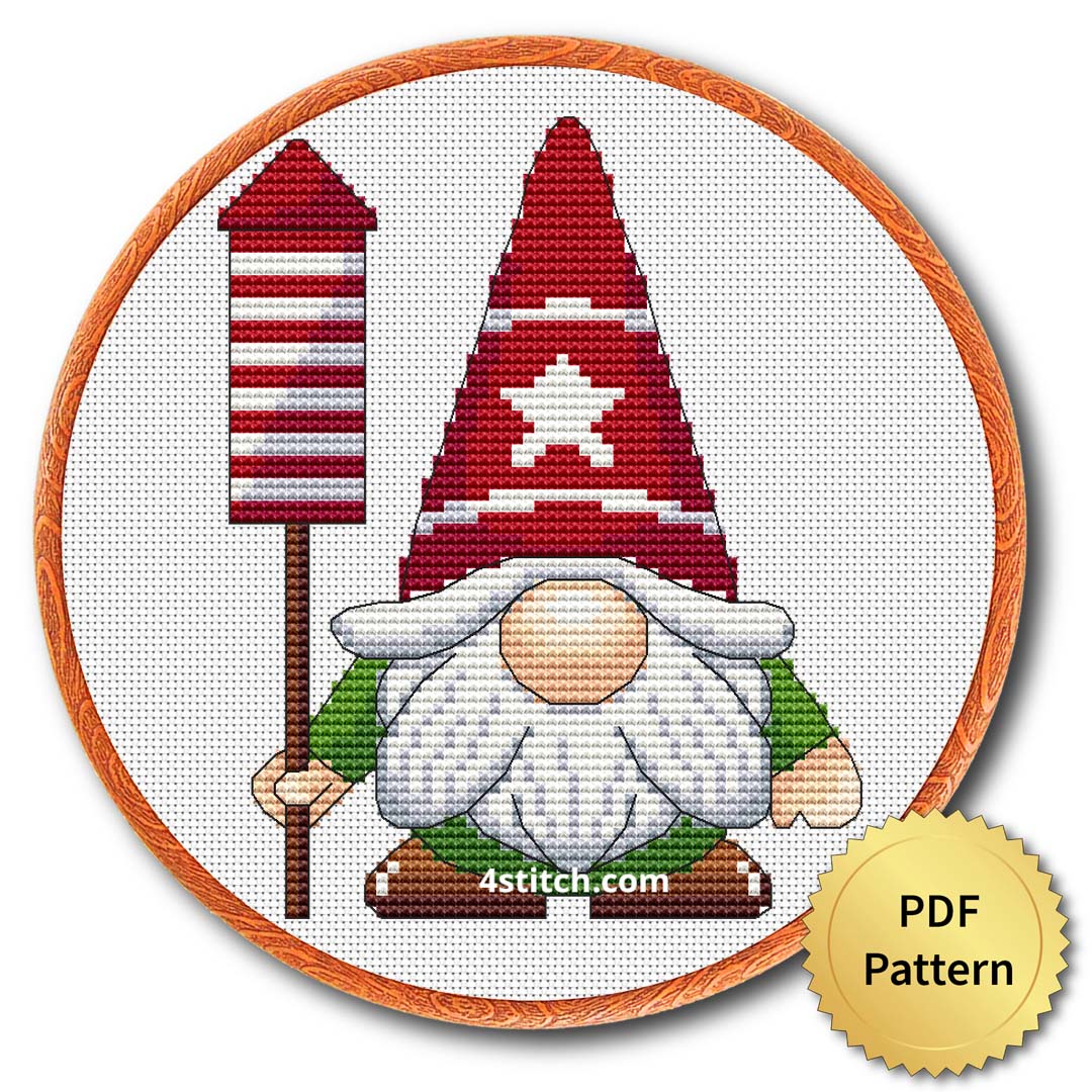 Christmas Rocket Gnome Cross Stitch Pattern shown in an embroidery hoop with a gold PDF Pattern medal