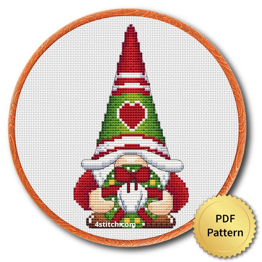 Christmas Wreath Gnome Cross Stitch Pattern shown in an embroidery hoop with a gold PDF Pattern medal