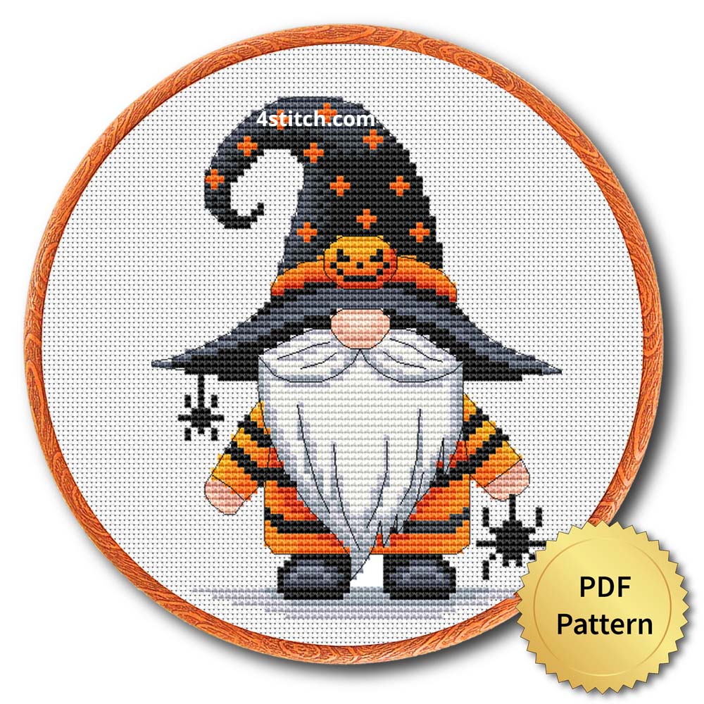 Spider Pumpkin Witch Gnome displayed on white Aida in a wooden embroidery hoop with a PDF pattern badge