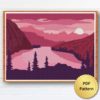 A cross stitch pattern of a pink and orange sunrise over a mountain range, with silhouetted trees in the foreground.