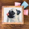 A cross stitch pattern featuring a cute pug puppy with its tongue out