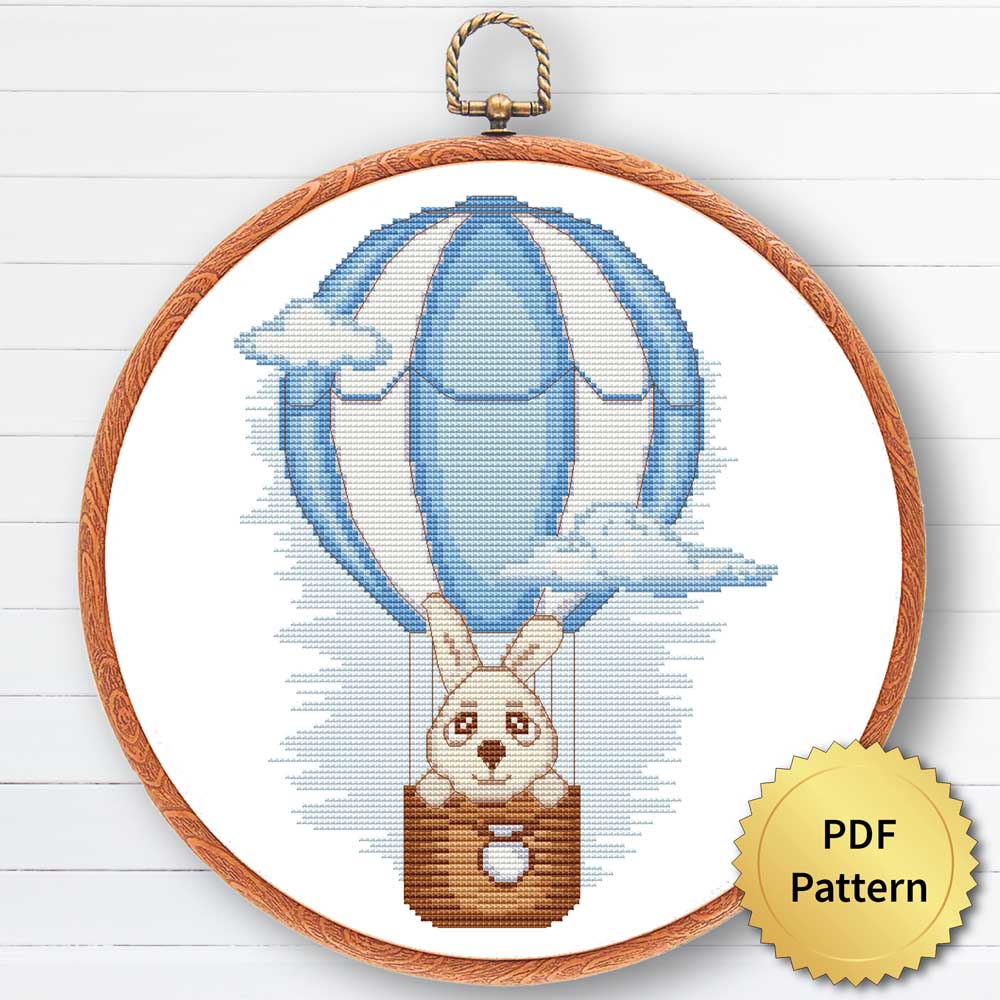 A cross stitch pattern featuring a cute bunny in a balloon