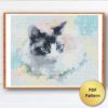 A cross stitch pattern featuring a watercolor style cat with bright blue eyes and a playful expression