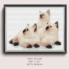 A cross stitch pattern featuring three cute white kittens cuddling together