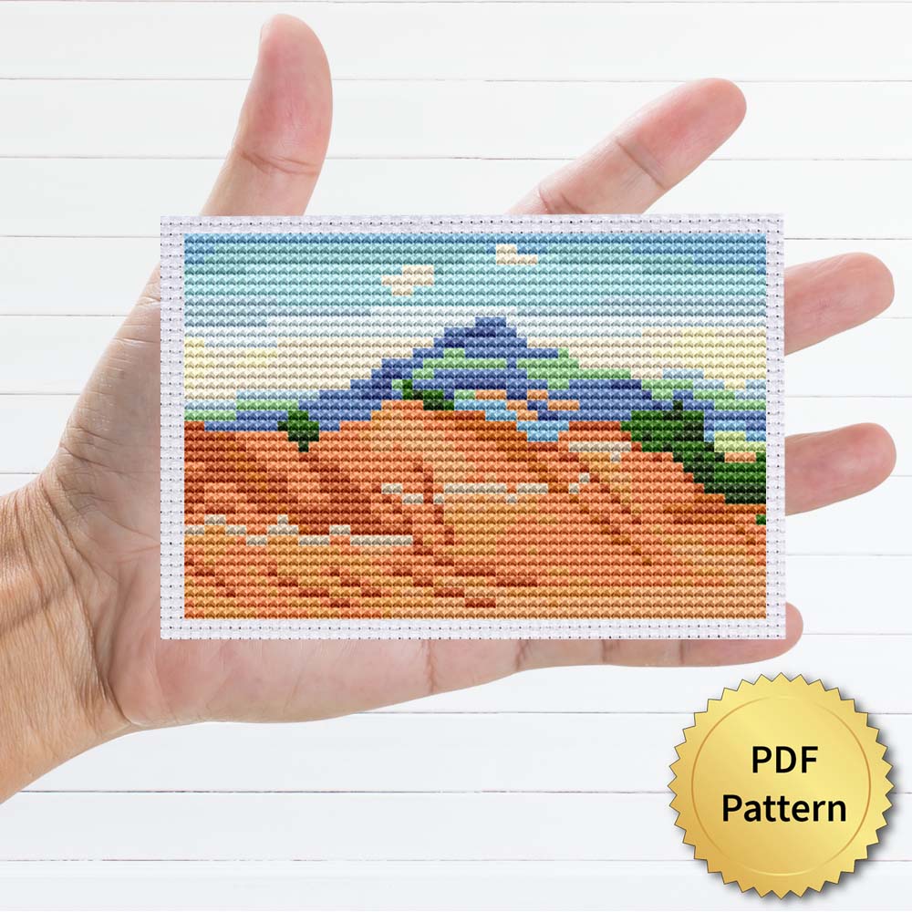 Red Hills with Pedernal, White Clouds by Georgia O'Keeffe cross stitch pattern - Artistic embroidery inspired by O'Keeffe's masterpiece