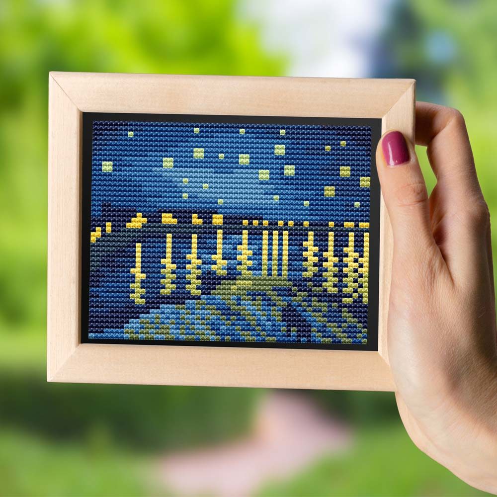 Starry Night Over the Rhone cross stitch pattern featuring a stunning reproduction of the famous Vincent van Gogh painting
